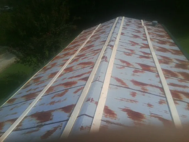 Rusted metal roof panels with new wood purlins before replacement — Storm Damage Roof Repair in Valley City by Roofing Brothers